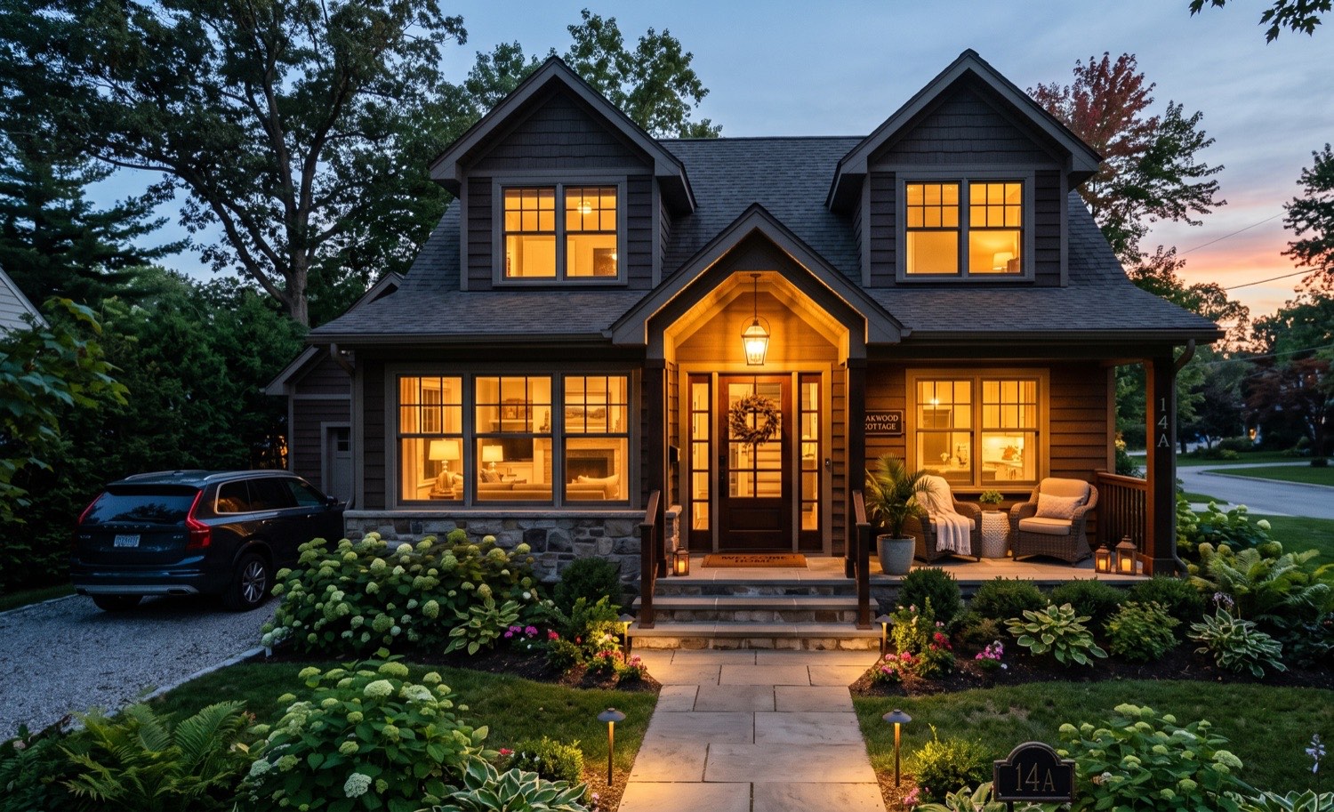 A short-term rental home at dusk with warm interior lighting